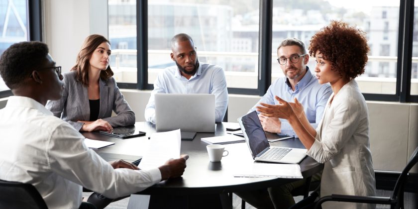 business woman addressing colleagues at a meeting
