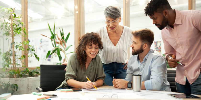 Young adult businesswoman presenting work to coworkers